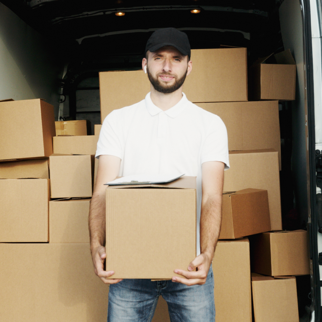 Smiling courier driver holding a parcel.